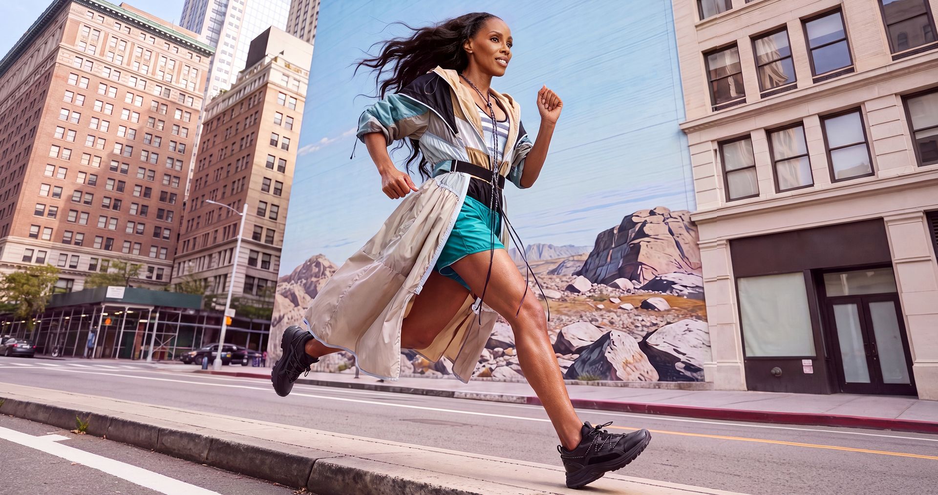 Woman running down a city street wearing black sneakers.