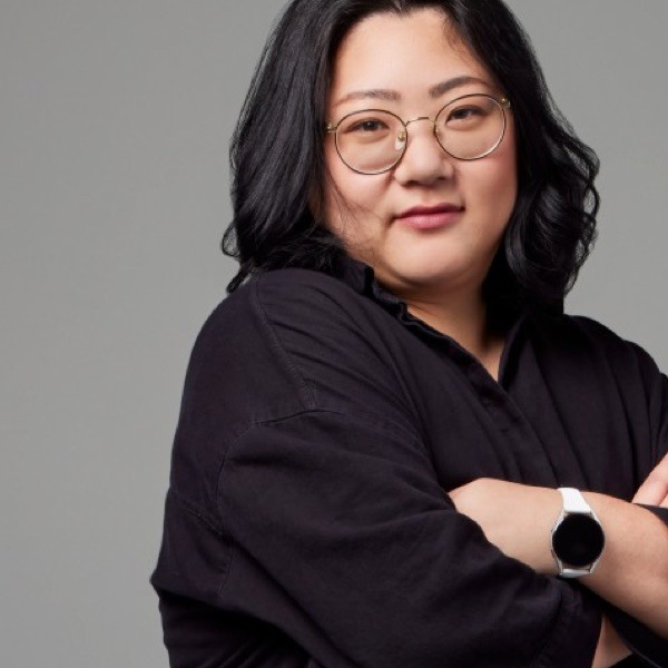 woman with dark hair and glasses