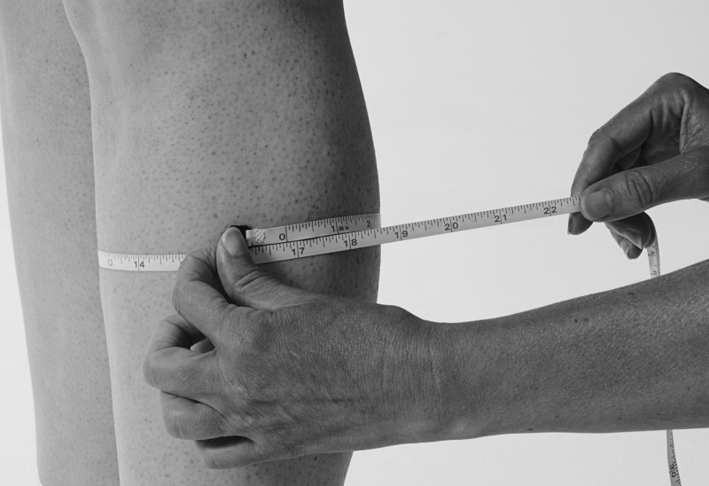 model standing to have her calf and foot measured