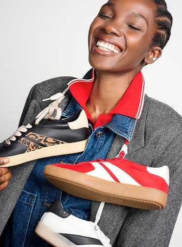 model wearing 3 Medina sneakers, in different color ways, around her neck