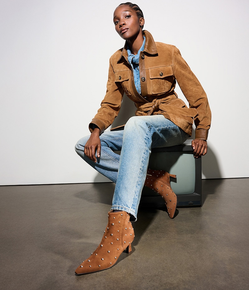 model wearing the Deesha bootie in brown suede stud