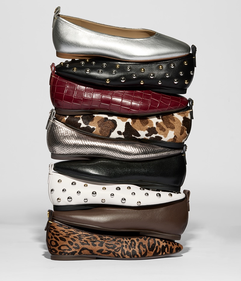 stack of the Carla ballet flats in various color ways