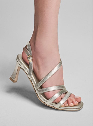 A model for Naturalizer modeling a silver Naturalizer heel