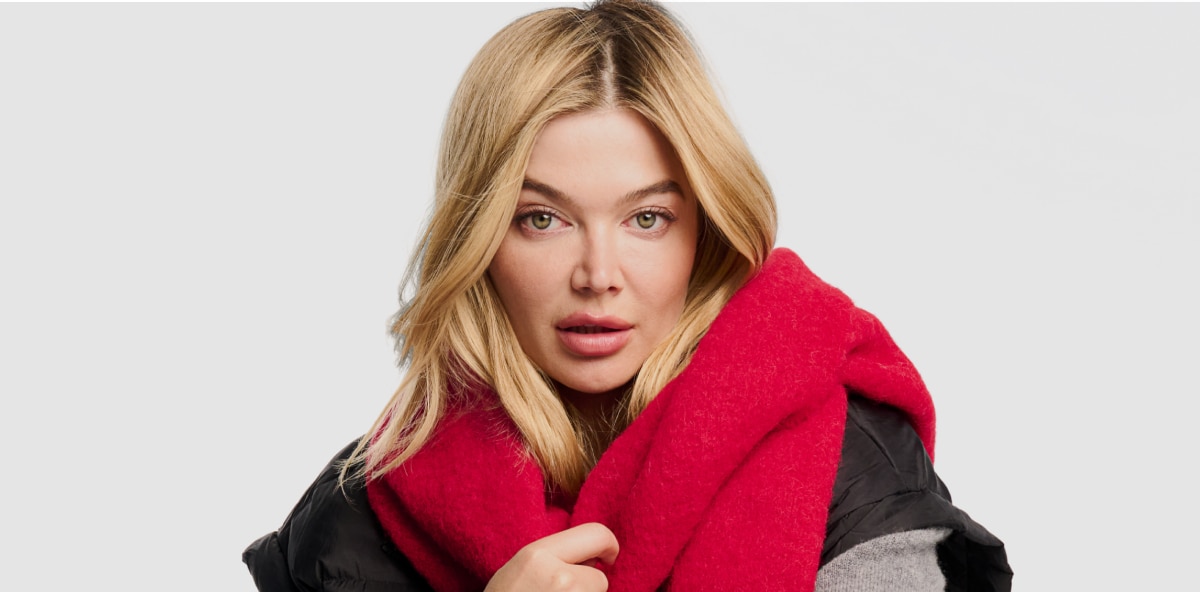 blonde model wearing a red scarf around her neck